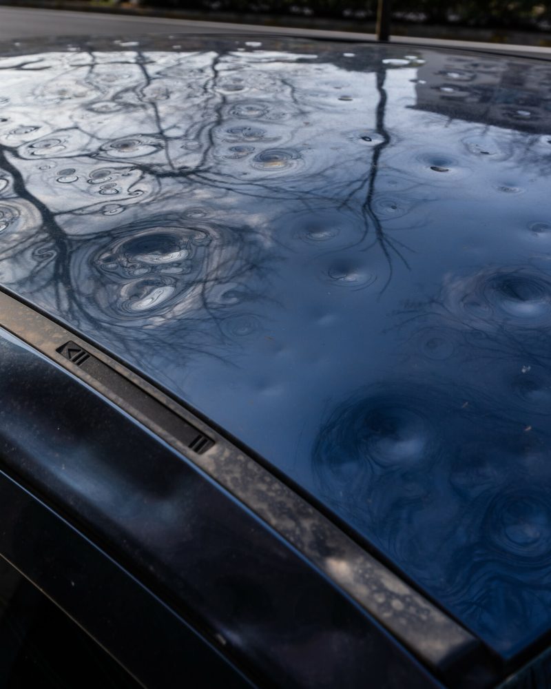 detail of the roof of the car damaged by hail. damage from natural disaster. hail damage